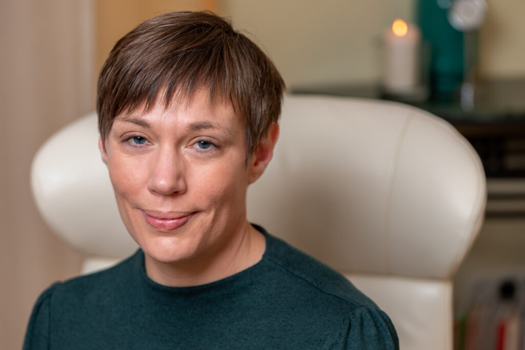 Dorothee Hildbrand blickt ruhig und offen in die Kamera – in einer warmen, stillen Atmosphäre, die für inneren Raum und Selbstverbindung steht.